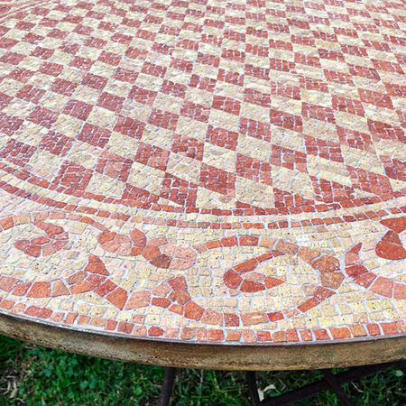 Mosaic tabletop featuring a central geometric pattern, with a flowing external pattern. Made from salvaged antique terracotta