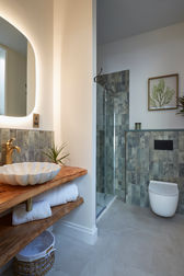Impressive ensuite with a custom made vanity unit and stunning wall tiles