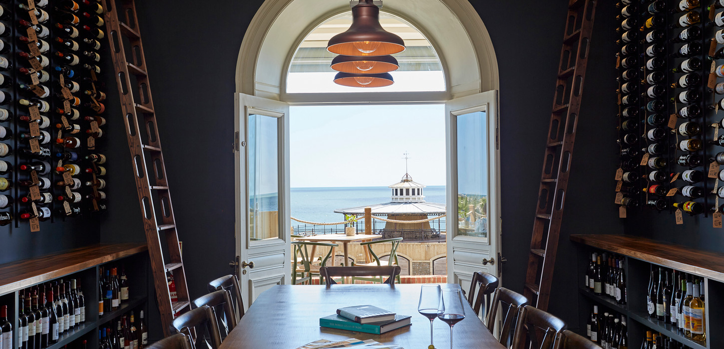 Moody wine tasting experience room with rich wood tones in a Victorian hotel designed by Vivus Interiors on the Isle of Wight
