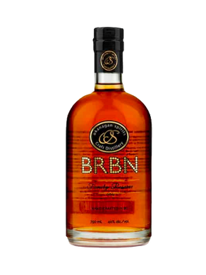Bottle of BRBN whiskey with a black and gold label. Text reads "Okanagan Spirits Craft Distillery." Warm amber liquid inside.
