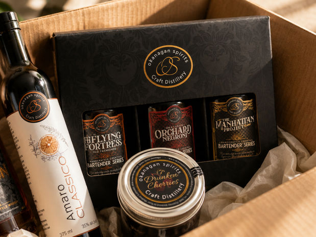 Gift box showcasing a premium selection from Okanagan Spirits Craft Distillery, featuring handcrafted liquors and a variety of cocktail essentials.