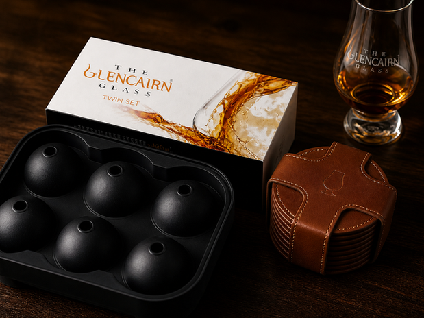 Enhance your bourbon experience with top-notch accessories: Glencairn glasses, a sleek ice mold, and elegant leather coasters.