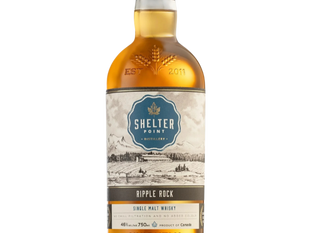 Bottle of Shelter Point Ripple Rock single malt whisky on black background, amber liquid, labeled Product of Canada.