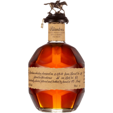 A beautifully crafted bottle of Blanton’s Original Single Barrel Bourbon, featuring an elegant horse and jockey topper, showcases its amber-hued spirit and artisanal attention to detail with a handwritten label.