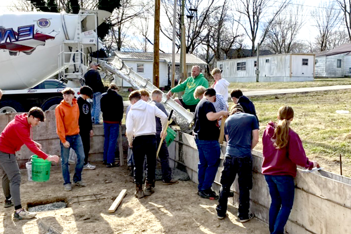 DCTC Construction Technology Class pouring concrete for foundation of Benton Street home