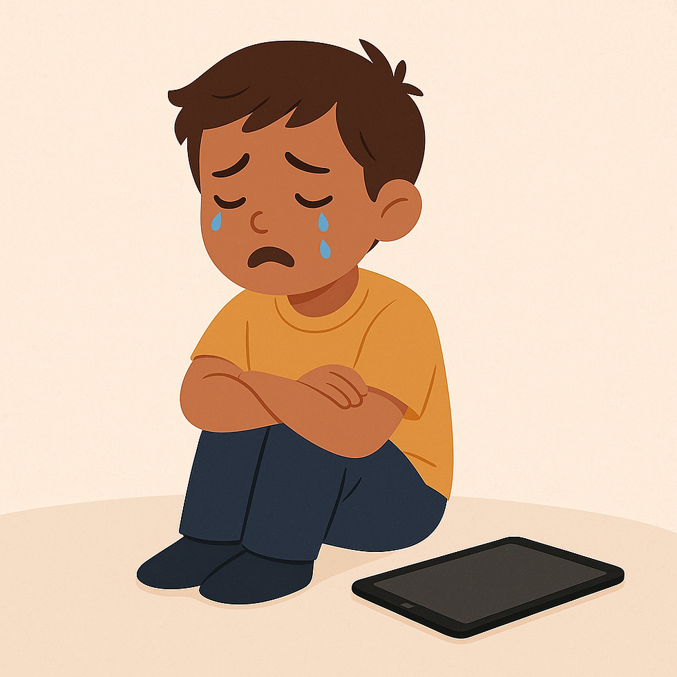 A sad child sits on the floor with tears streaming down their face, next to a tablet.