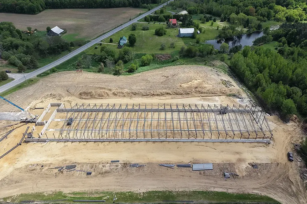 Vue du ciel montrant la charpente métallique longue portée du nouveau bâtiment agricole de 464 pieds.