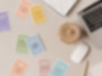 Therapeutic prompt cards on a desk with a laptop