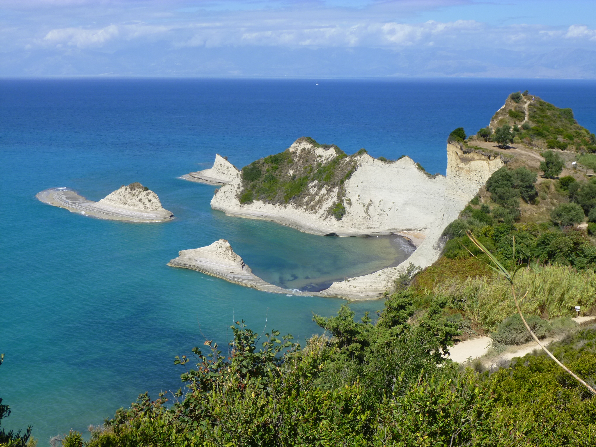 No regular sunbed or parasol service is available at the small coves; bring your own shade and supplies.