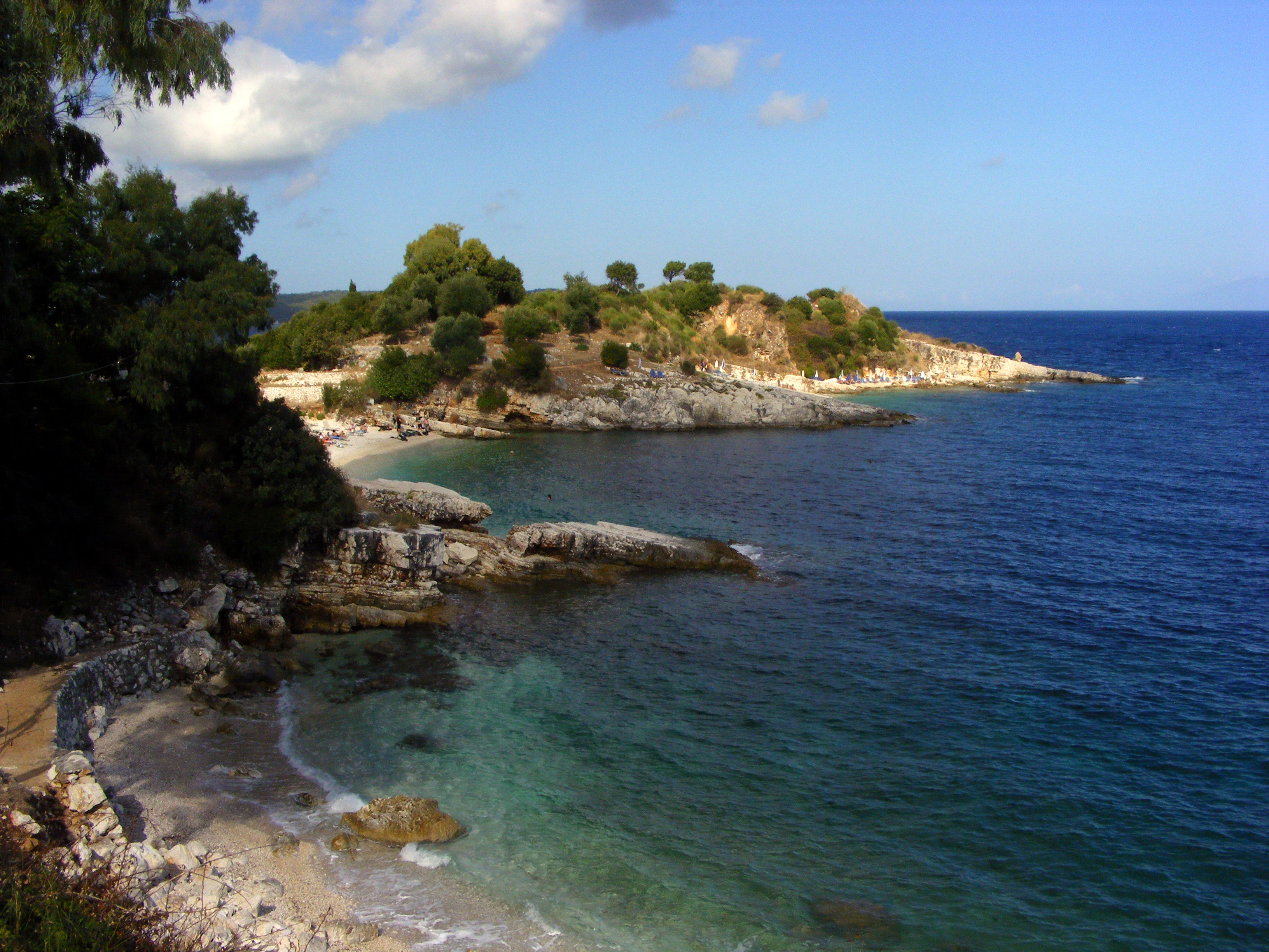 Seasonal sunbeds and parasols are available on this very small beach.