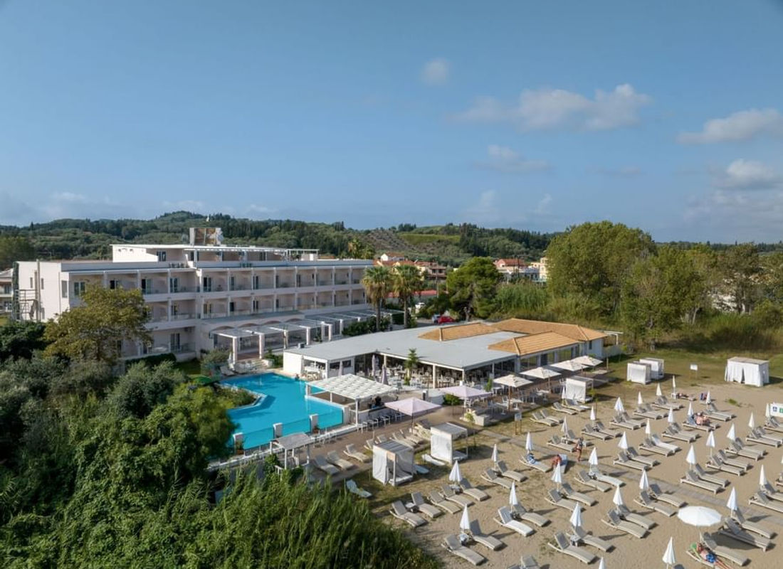 Aerial view of Cavomarina Beach hotel and beachfront in Kavos, Corfu