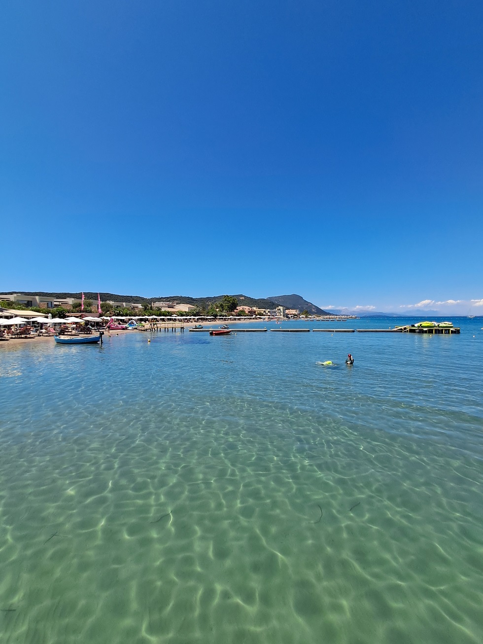 Seasonal sunbeds and parasols are available along organised sections.
