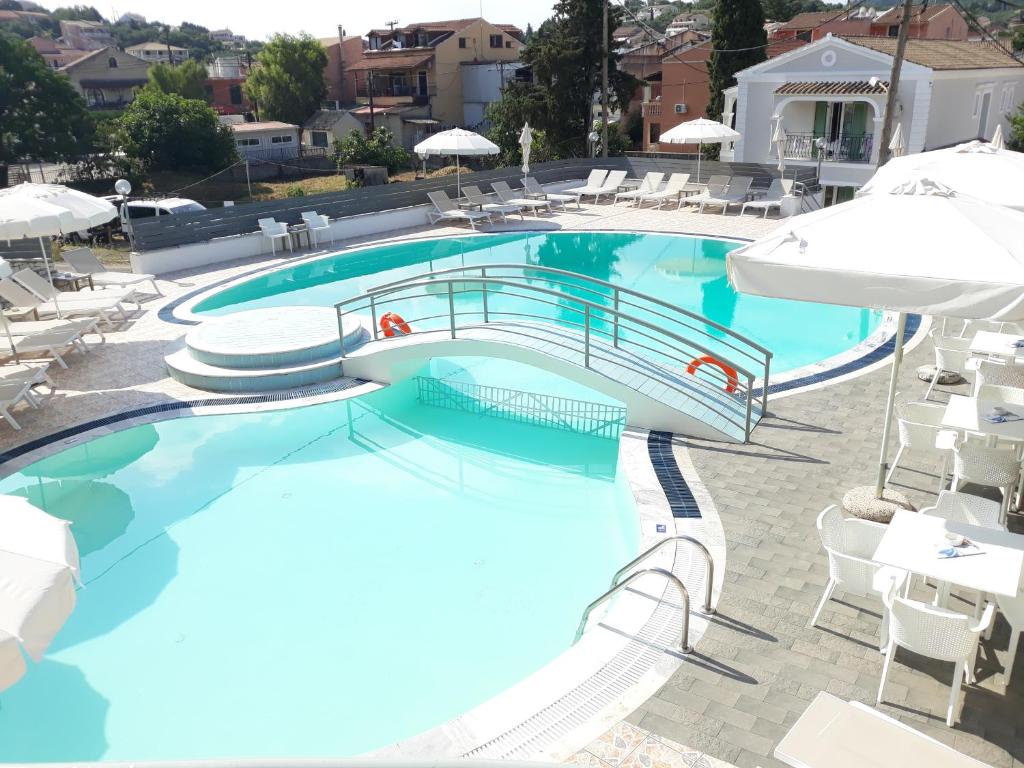 Swimming pool and loungers at Kalimera Apartments, Kassiopi