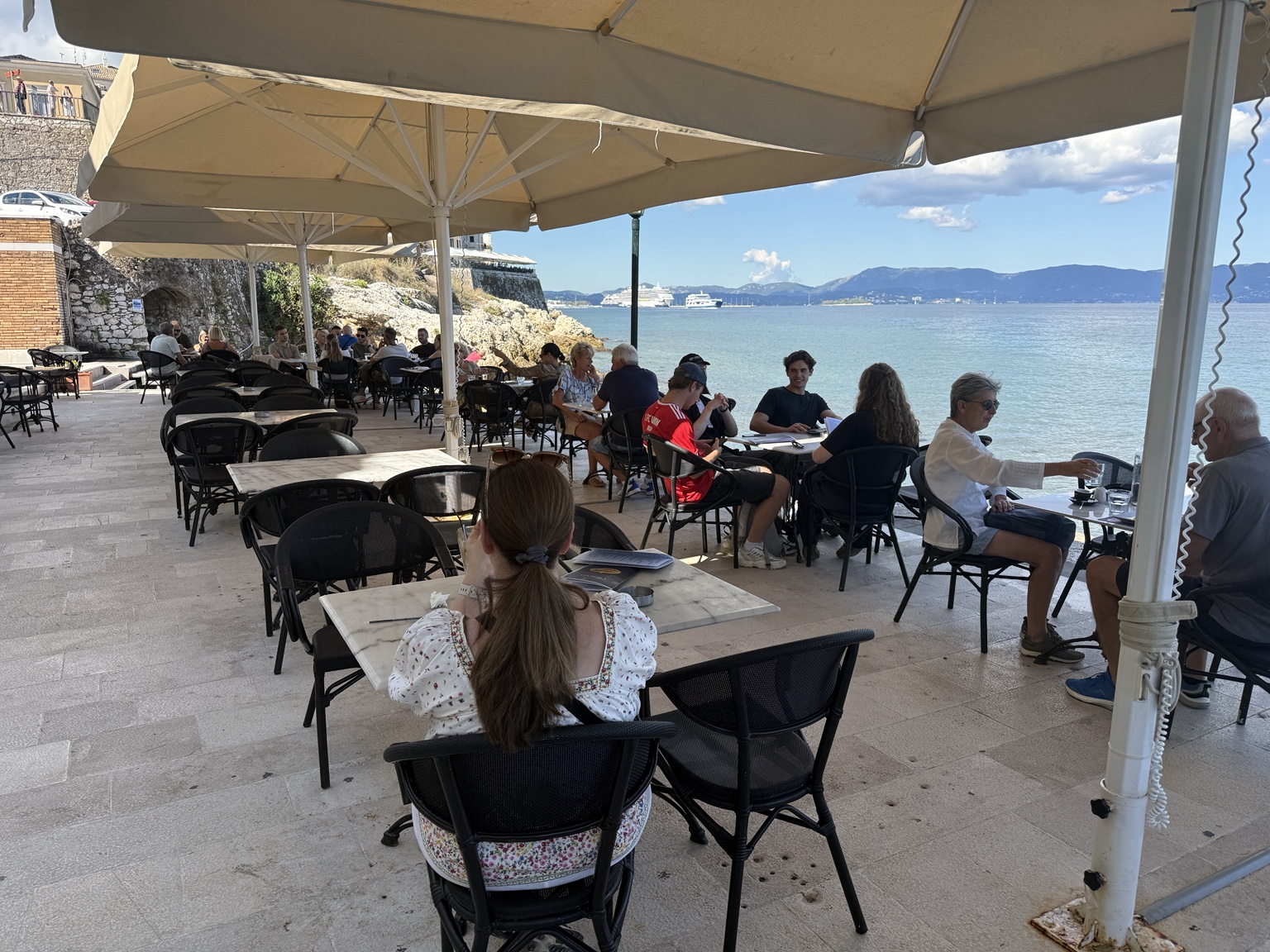 Waterfront terrace at Faliraki Cafe Restaurant in Corfu Town, overlooking the Ionian Sea
