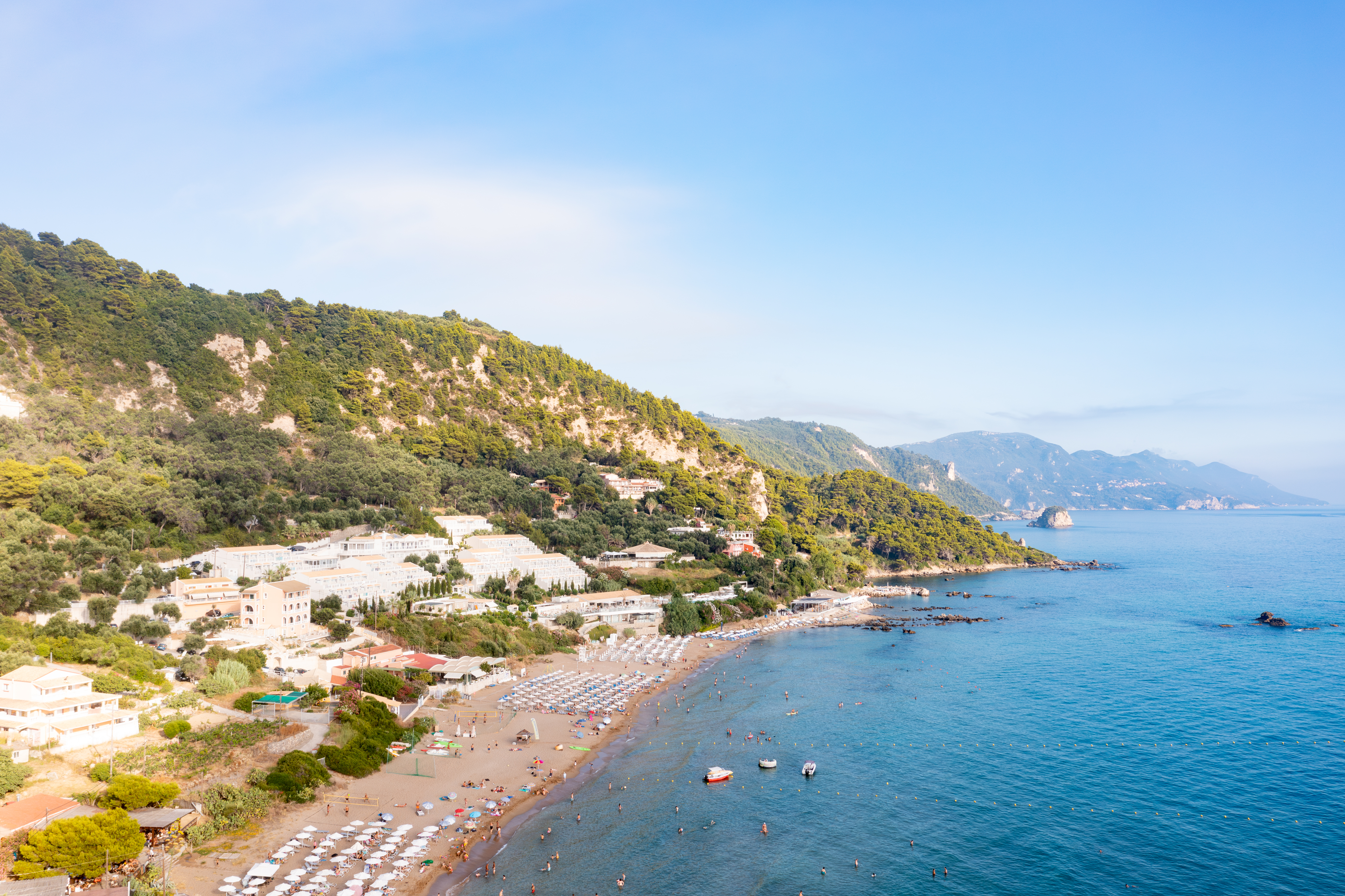 Seasonal sunbeds and parasols are available along the organised beach.