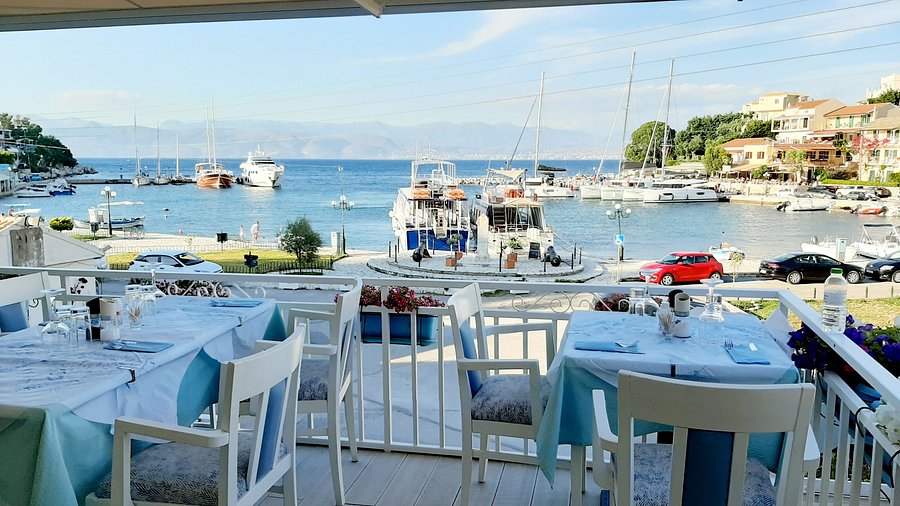 Petrino Restaurant open-air dining overlooking Kassiopi harbour, Corfu