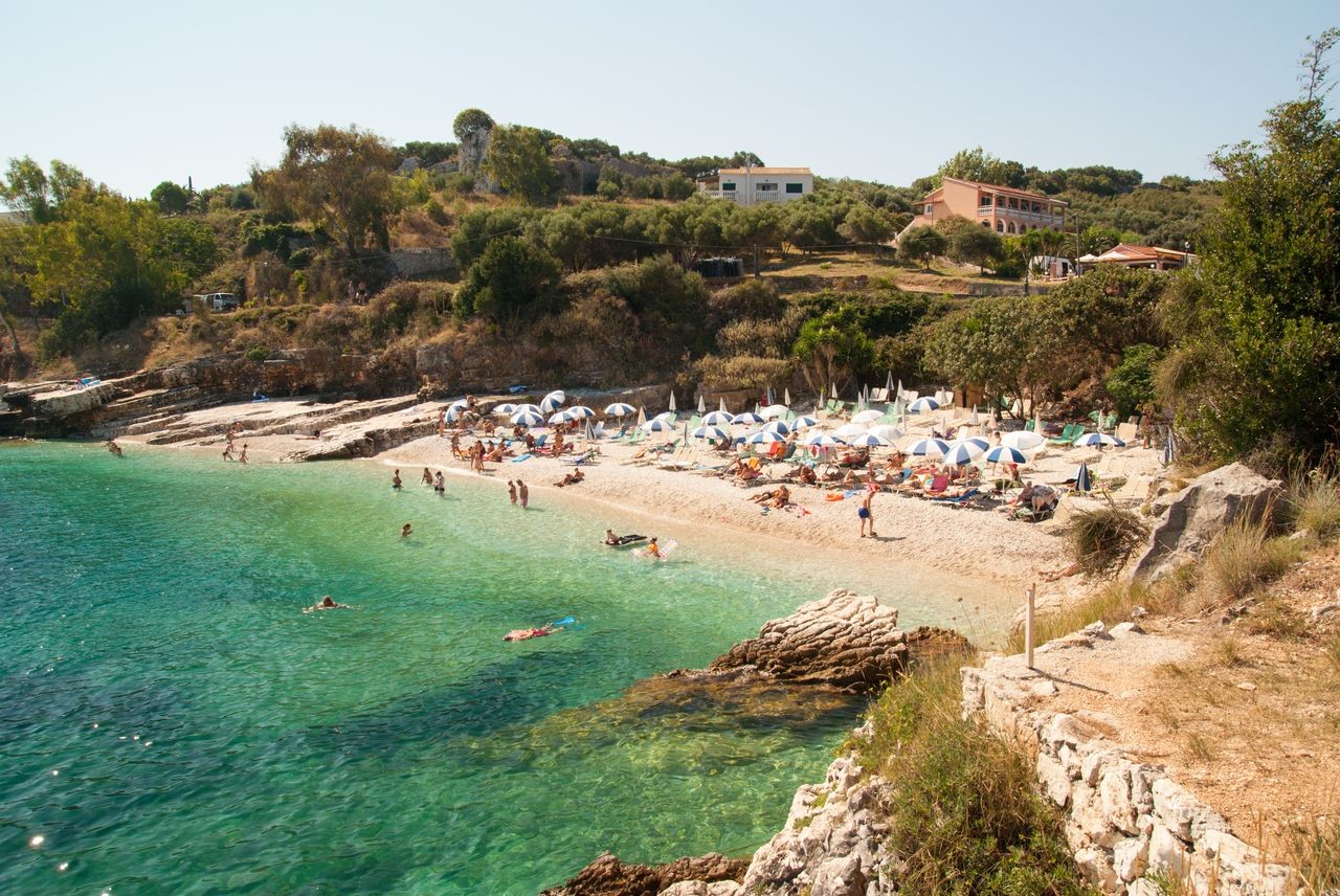 Some parts of the rocky bathing area have seasonal sunbeds and parasols; other flat rock sections are used with towels.