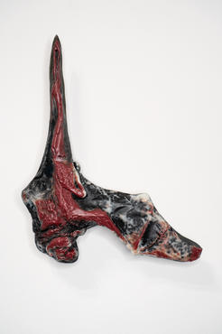 Single cast glass vampire Bat with an outstretched wing in red, white, clear, and black on a white background