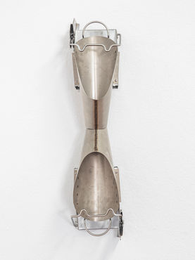 Close up view of metal sculpture on a white wall 