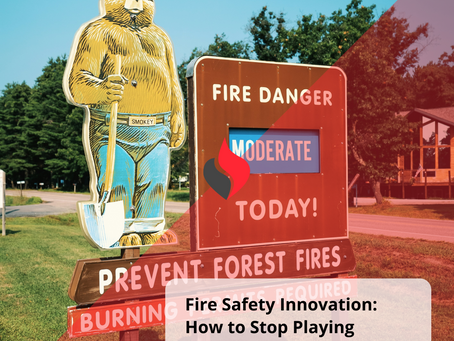 Smokey Bear fire danger sign showing "Moderate" fire risk today, with clear weather and cabins in the background, symbolizing outdated fire safety messaging in contrast with the need for modern innovation.