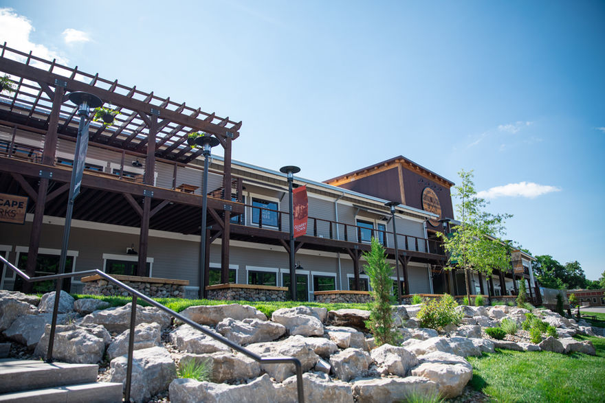 Angled exterior photo of the beige, white and brown multi-use, two-story business facility.