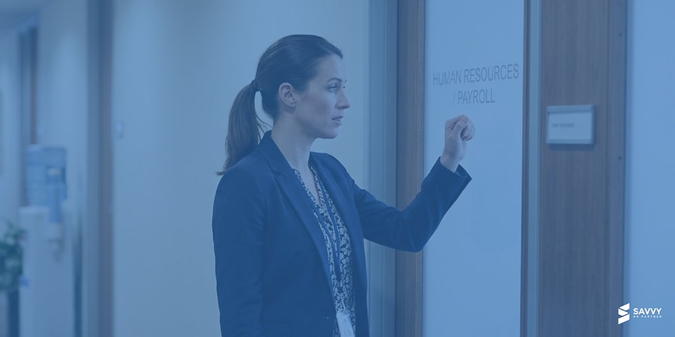 A female employee in a business suit knocking on a glass door labeled 'HUMAN RESOURCES / PAYROLL' in an office hallway.