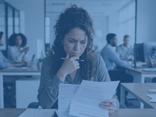 An office worker contemplatively reviews a payroll document at her desk in a sharp, realistic scene representing her decision-making process.