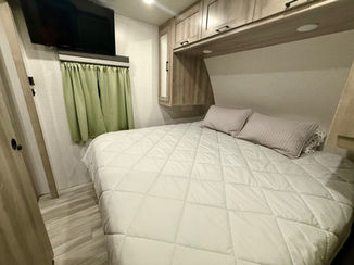 2022 Winnebago Voyage 2427RB travel trailer with king-size bed, spacious rear bath, and fully loaded kitchen, available for hassle-free RV rental at Lake Whitney.
