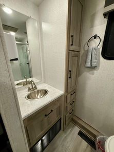 2022 Winnebago Voyage 2427RB travel trailer with king-size bed, spacious rear bath, and fully loaded kitchen, available for hassle-free RV rental at Lake Whitney.