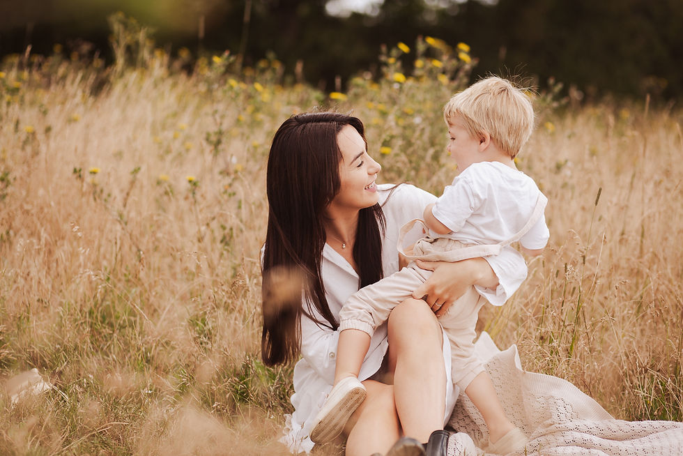 Portrait of a mother tickling her son in a golden field by Chelmsford family photographer