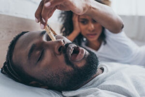 Woman annoyed with mans snoring caused from sleep apnea