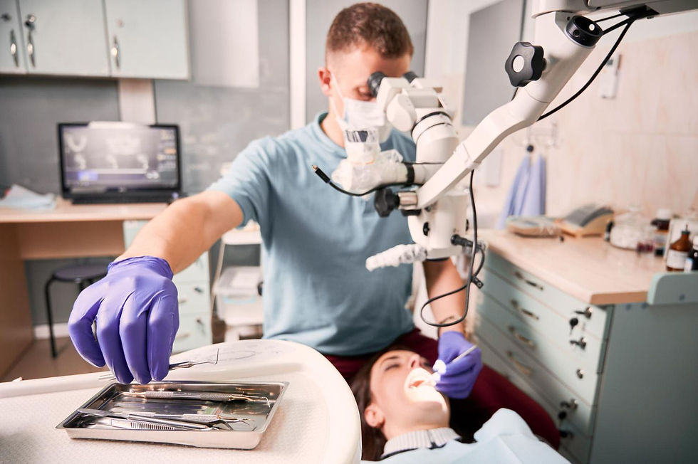 Male Dentist Working With Patient