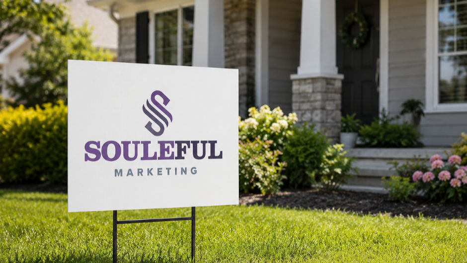 Yard sign with "Souleful Marketing" in purple on green grass, house entrance with wreath in background, bright and sunny setting.