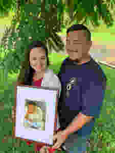 Latisha and Jered hold a picture of their son, Taite.