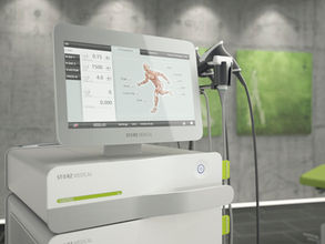 STORZ Medical shockwave therapy device with touchscreen interface displaying anatomical treatment areas, placed in a modern clinical setting.
