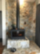 Modern black wood heater on stone fireplaces Armidale.