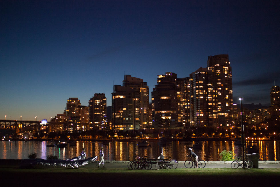 Night city skyline with cyclists