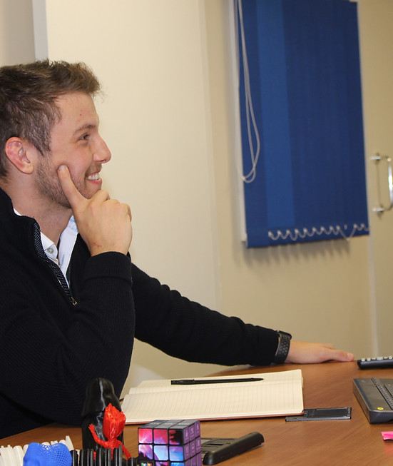 Professional man smiling at office desk