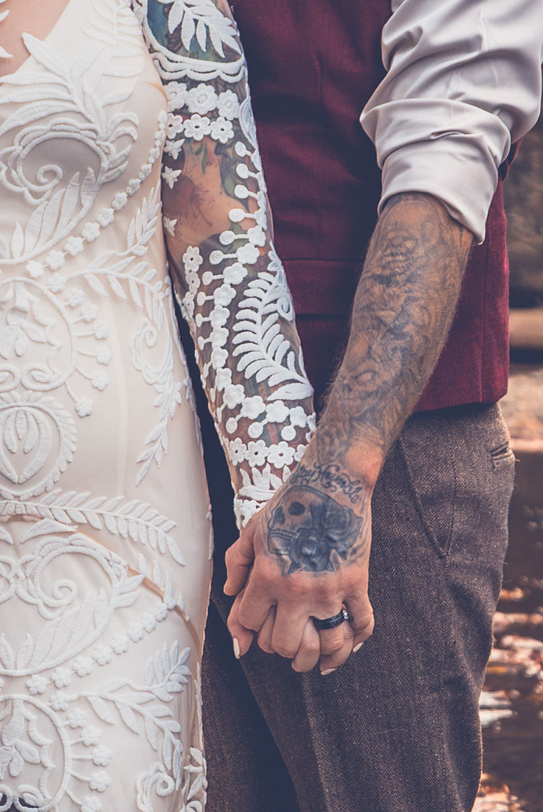 Tattoos and lace add texture to couple's portrait