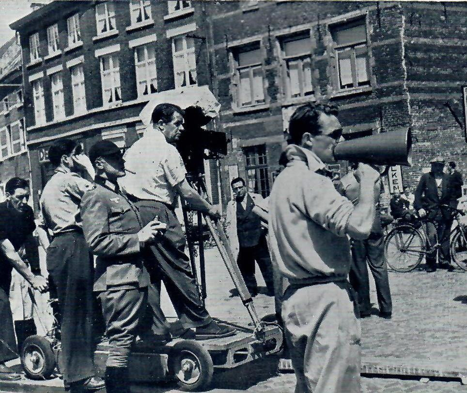 Marius Goring in uniform stands behind the camera with director Compton Bennett in front of him on the dolly at the side of the camera