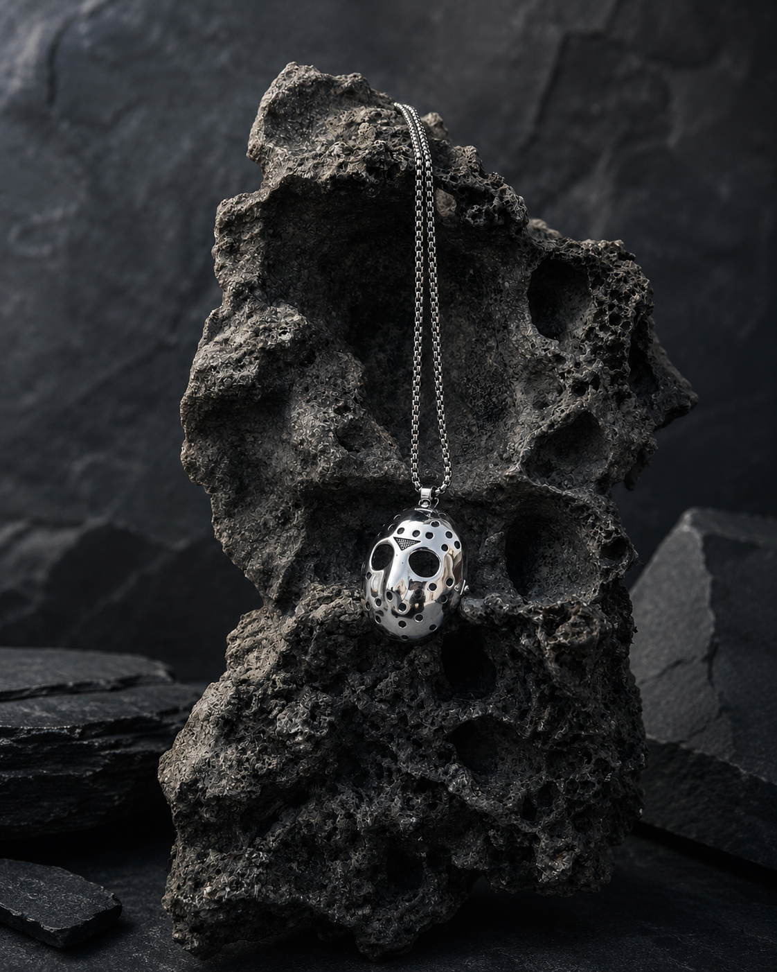 Steel Mask Stainless Steel Necklace styled on dark textured stone with a moody gothic background.