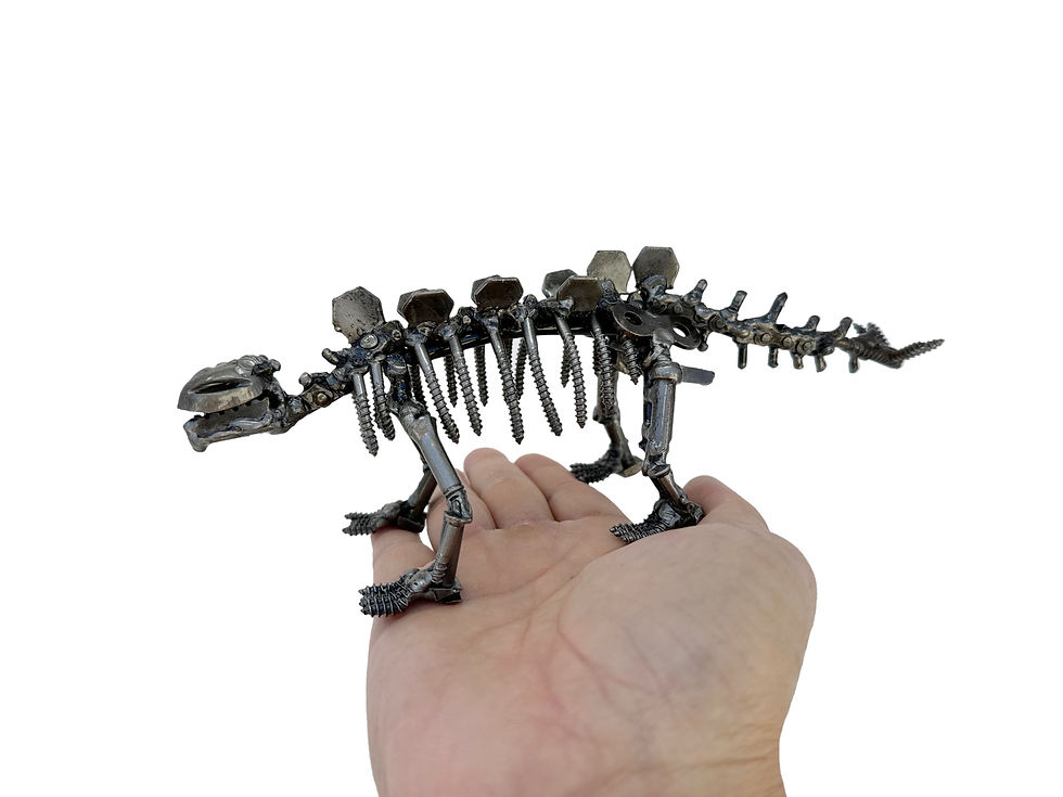 Thumbnail: Stegosaurus metal sculpture displayed in hand for size reference