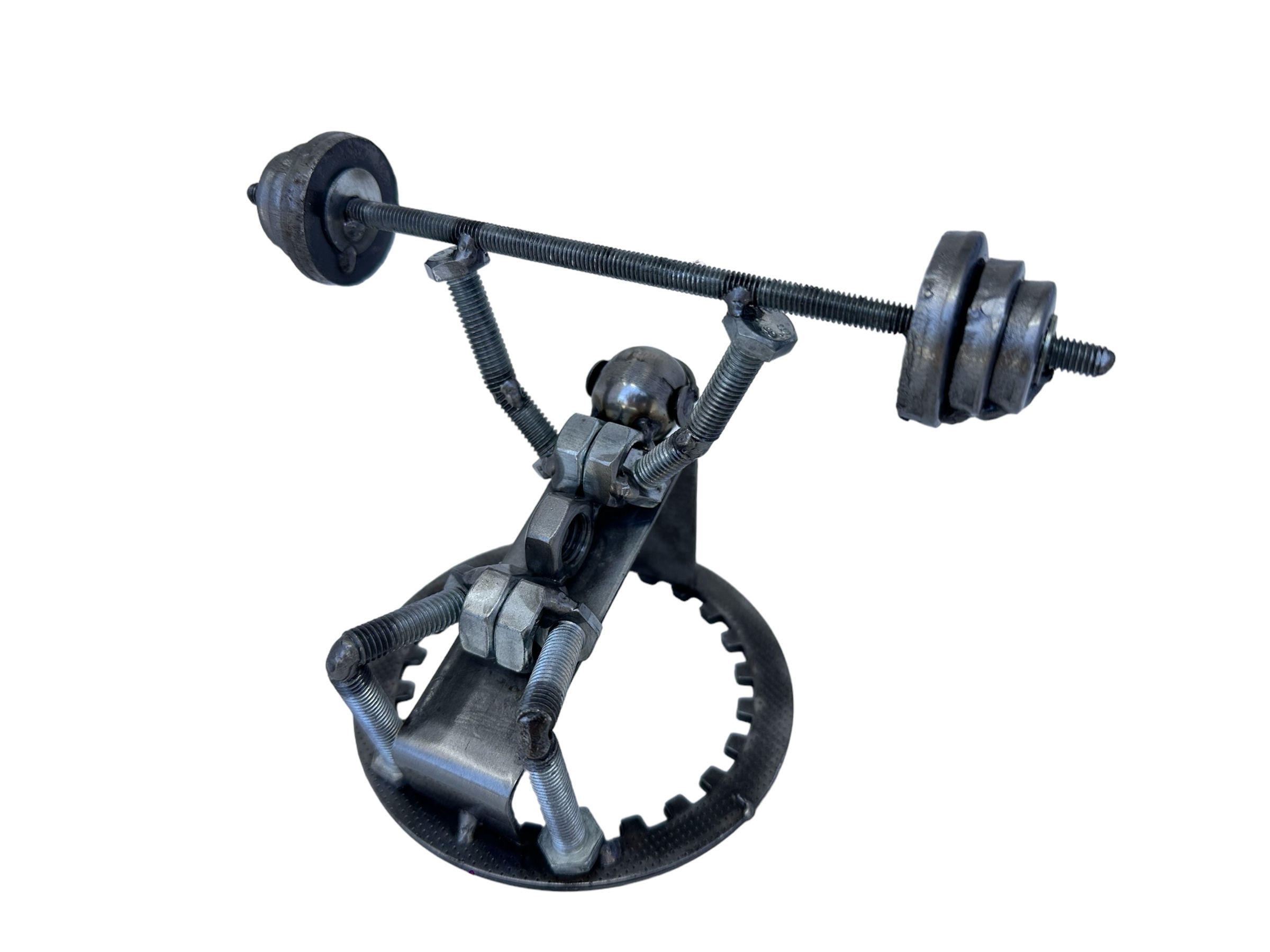Scrap metal gym sculpture of weightlifter on bench press, handmade from bolts and gears.