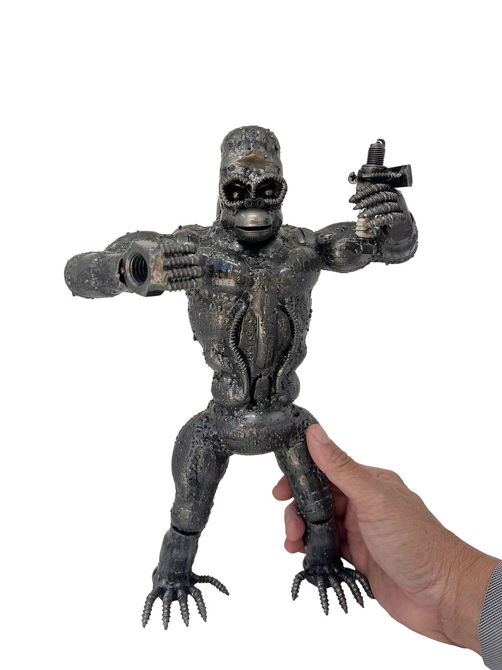 Thumbnail: King Kong inspired recycled metal sculpture being held by hand to show handmade welded metal details and size.