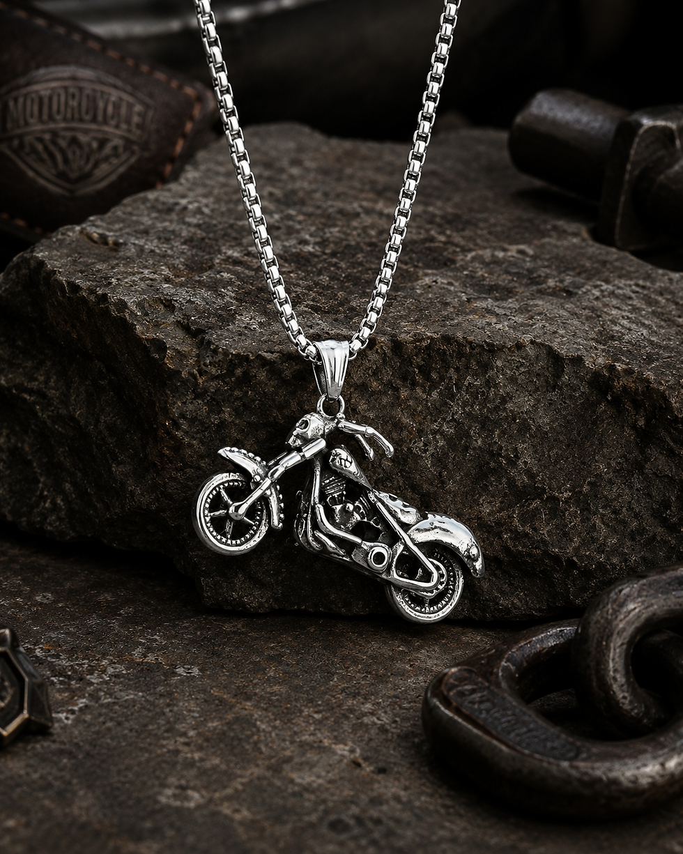 Skeleton Rider Motorcycle Stainless Steel Necklace shown on rugged stone with biker-style background.