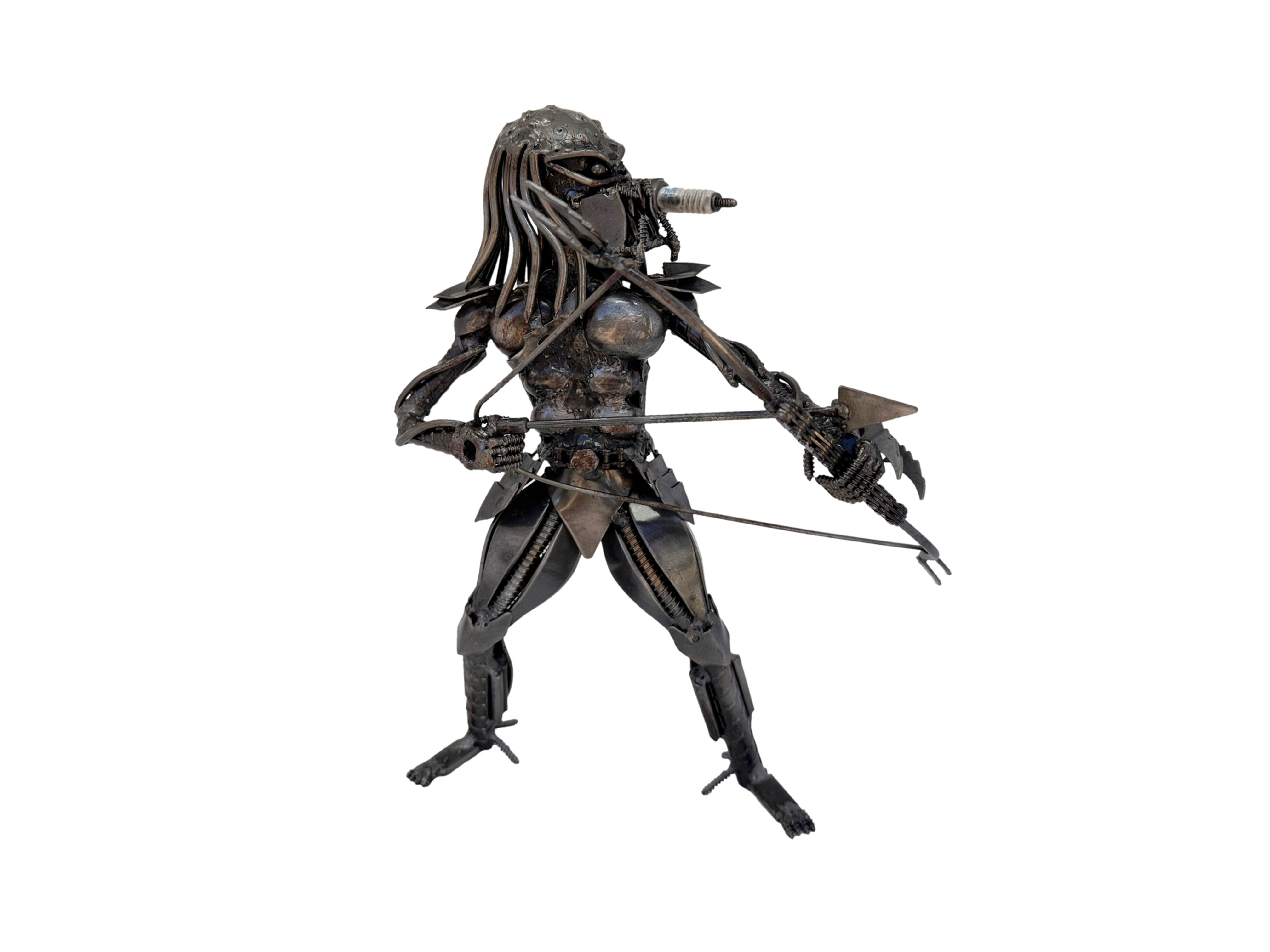 Hunter’s Aim Predator-inspired recycled metal sculpture holding a bow and arrow – handmade by Metalsouls.