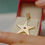 Thumbnail: Minha Estrela – Ethical Gold Star Pendant with Ruby