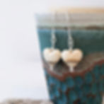 Sand Heart Drop Earrings, pottery background