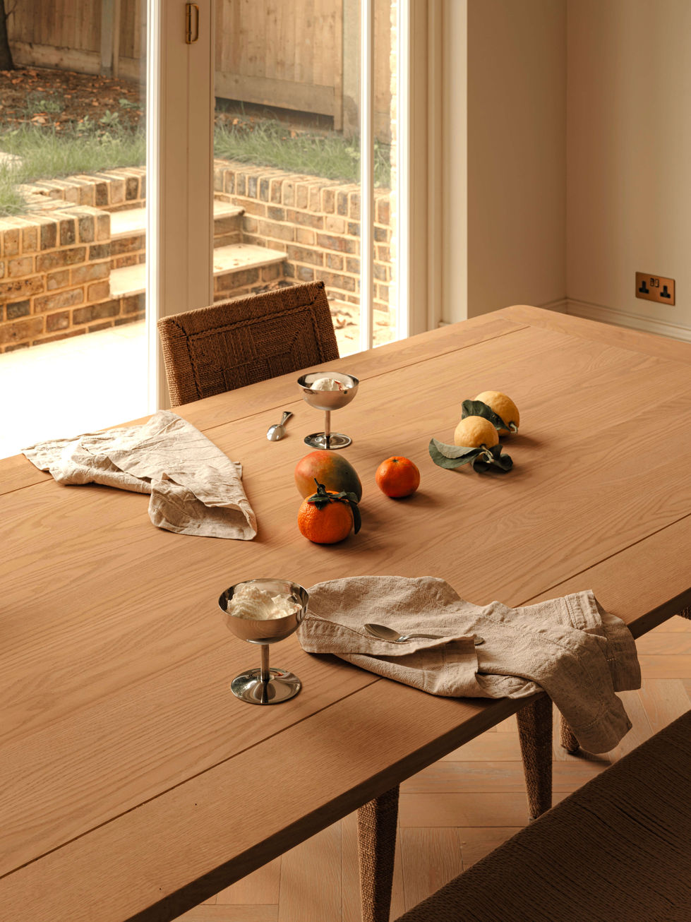 tak-studio-chelsea-dining-room-lifestyle-oak-table-rattan-chairs-garden-doors.jpg