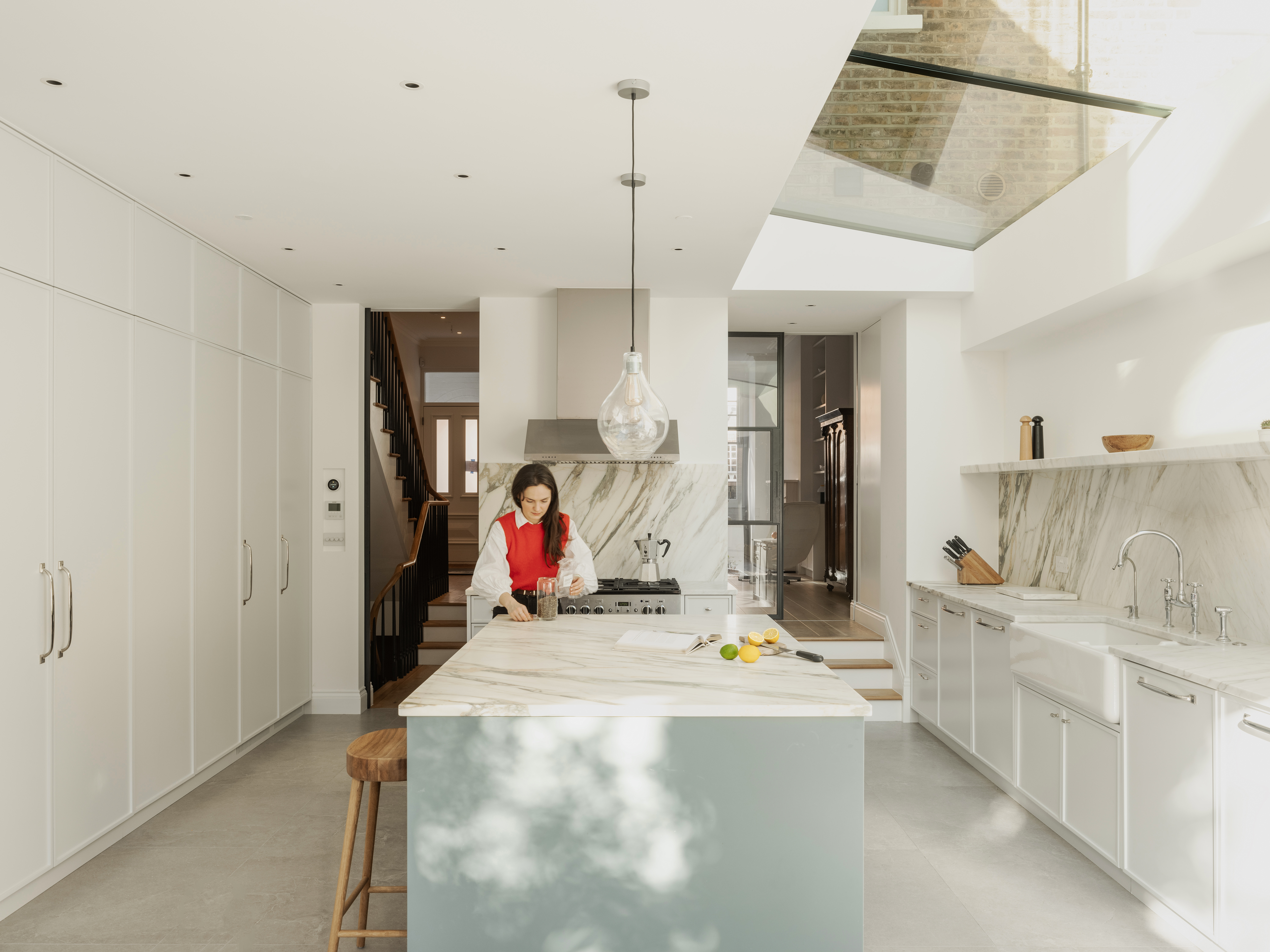 TAK Studio Ltd — Light-filled open plan kitchen of bespoke design with marble worktop in London